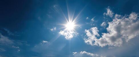 The Sun Shining Brightly in a Clear Blue Sky with Fluffy Clouds photo