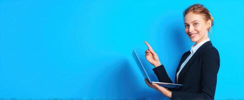 The professional woman showcasing technology with a laptop against a vibrant blue background. photo