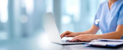 The healthcare professional using a laptop for efficient patient management. photo