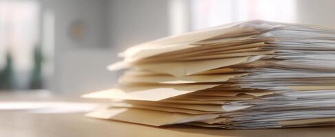 The stack of organized documents in a bright office workspace. photo