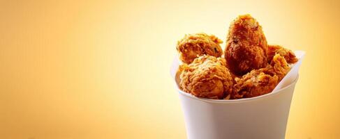 The Crispy Fried Chicken in a Bucket Surrounded by Warm Lighting photo
