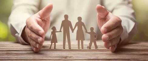 The delicate hands protect a family silhouette representing love and unity. photo