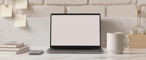The sleek laptop on a modern marble desk with coffee and stationery. photo