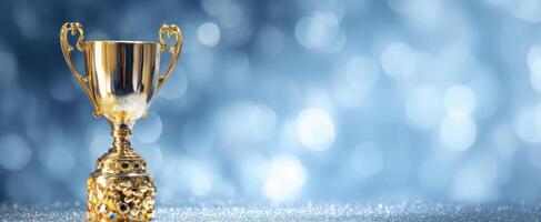 The golden trophy shining against a sparkling blue bokeh background. photo