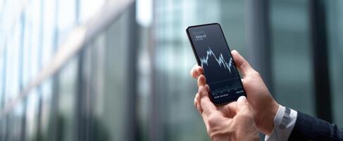 The smartphone displaying financial graphs in a professional setting. photo