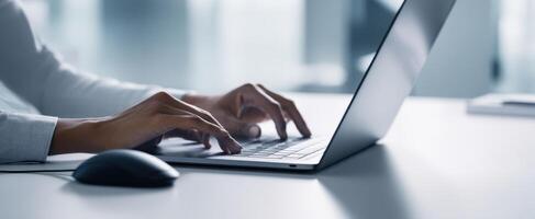 The Hands Typing on a Laptop in a Modern Office Environment photo