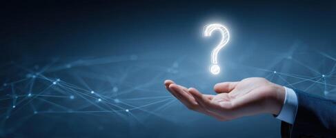 The Hand Holding a Glowing Question Mark Symbolizing Inquiry and Exploration photo