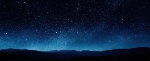 The breathtaking night sky filled with stars over distant mountains. photo