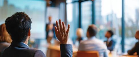 The engaged audience asking questions during a corporate presentation in a modern setting. photo