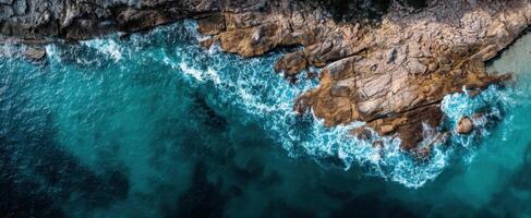 The breathtaking ocean waves crashing against rocky coastline at sunset. photo