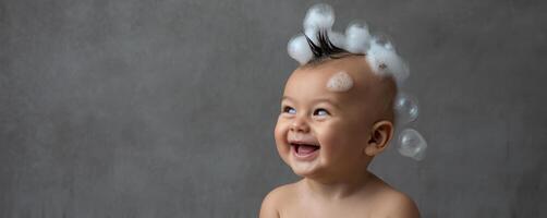 The joyful baby with bubbles and a charming smile on their face photo