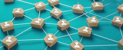 The network of interconnected wooden figures representing social communication and collaboration. photo