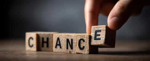The Hand Arranging Wooden Blocks to Spell 'Chance' for Motivation photo