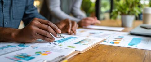 The hands reviewing analytics reports in a collaborative office environment. photo