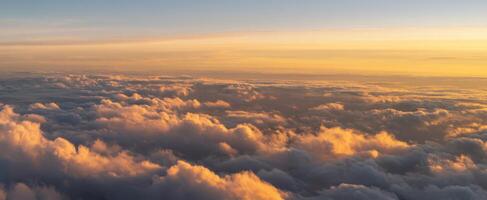The Serene Sunset Over Fluffy Clouds Illuminated by Soft Light photo