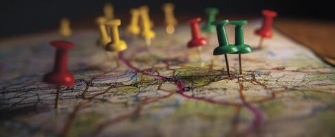 The vibrant pushpins marking locations on a detailed geographical map. photo