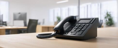 The sleek black telephone on a modern office desk. photo