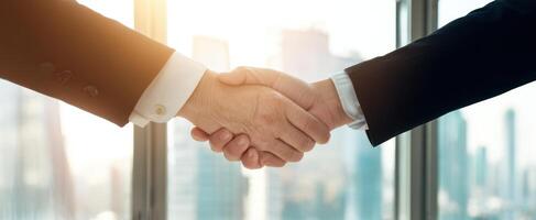 The handshake representing a successful business partnership in a modern office setting. photo