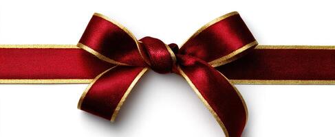 The red satin ribbon bow with golden trim ready for gift wrapping. photo