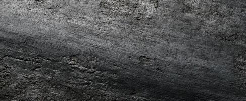 The textured surface of dark metallic background with subtle lines and imperfections. photo