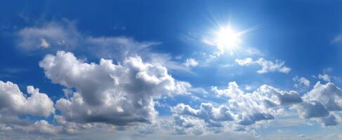 The expansive clouds illuminated by bright sunlight in a clear blue sky. photo