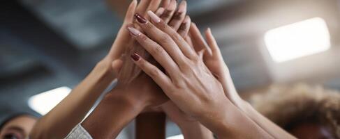 The hands of teamwork raised high in celebration and unity. photo