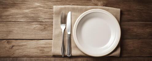 The elegant dining setup featuring a pristine plate on a wooden table. photo