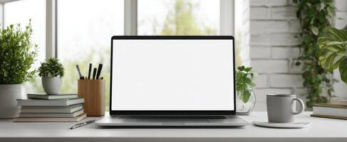 The laptop on a stylish desk surrounded by greenery and personal touches. photo