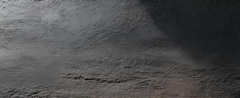 The textured gray surface with subtle shadows and intricate patterns. photo