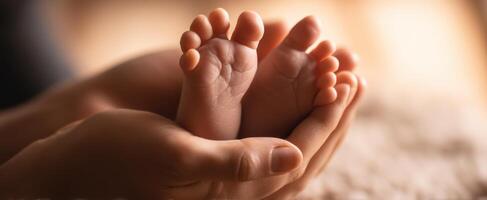 The gentle embrace of a newborn's feet in loving hands photo
