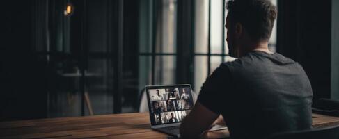The man participating in a conference call on his laptop. photo