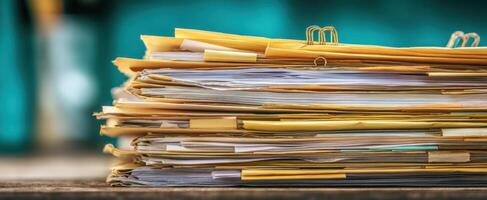 The stack of organized yellow folders filled with important documents photo