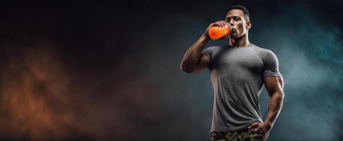 The muscular athlete enjoying a refreshing energy drink after a workout session. photo
