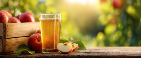 The refreshing golden cider beside fresh apples in a sunlit garden. photo