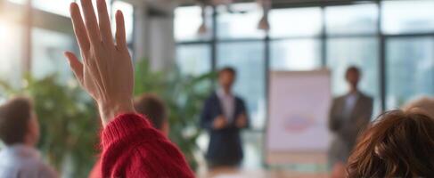 The engaged audience member raising hand during an interactive business presentation. photo