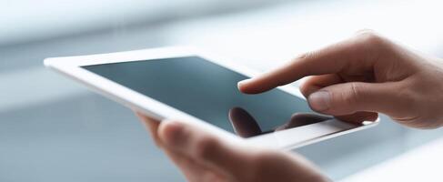 The sleek tablet held in hand showcasing user interaction with touchscreen technology. photo