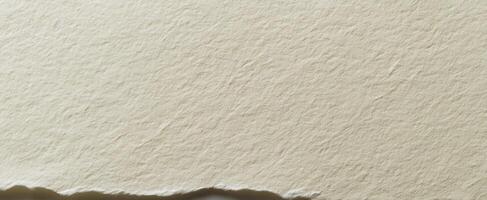 The textured surface of handmade paper with a rough edge for design inspiration. photo
