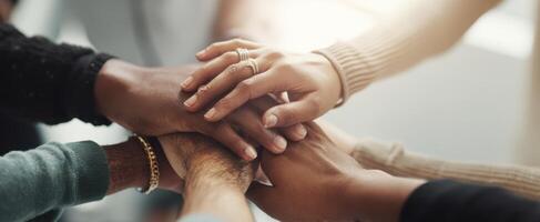 The hands of teamwork coming together in unity and support. photo