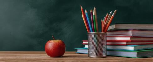 The vibrant arrangement of school supplies on a wooden desk for learning. photo