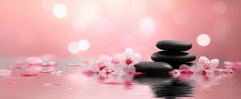 The tranquility of stacked stones with cherry blossoms and serene water reflection photo