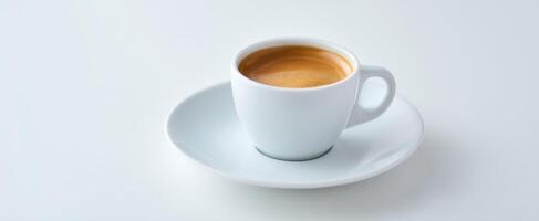 The elegant cup of espresso served on a minimalist white saucer. photo