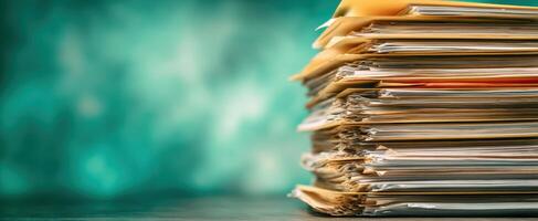 The stack of organized paperwork and folders on a desk background. photo