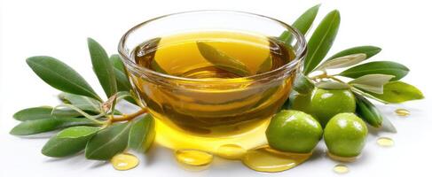 The Olive Oil in a Bowl Surrounded by Fresh Green Olives and Leaves. photo