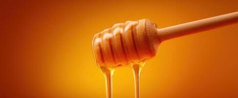 The Honey Dipper Dripping Golden Sweetness on a Warm Background photo