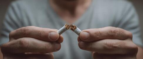 The decisive moment of breaking a cigarette to quit smoking for good photo