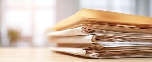 The stack of organized paperwork on a professional office desk setting. photo