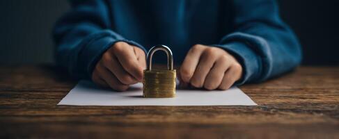 The padlock resting on paper in a child's hands. photo