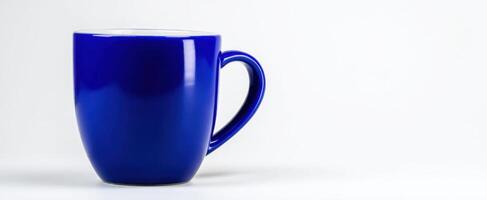 The elegant blue mug on a minimalistic white background. photo