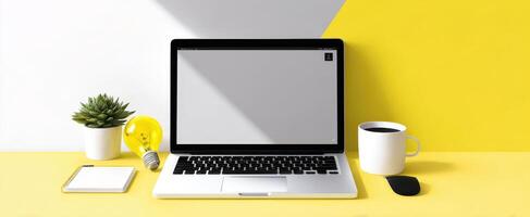 The modern workspace featuring a laptop and vibrant yellow accents. photo