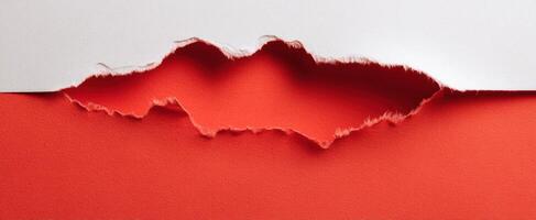 The Torn Paper Revealing Bold Red Background in Artistic Composition photo